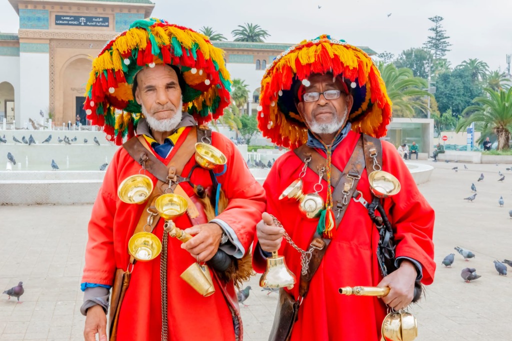 Traditional Moroccan water sellers in colorful costumes