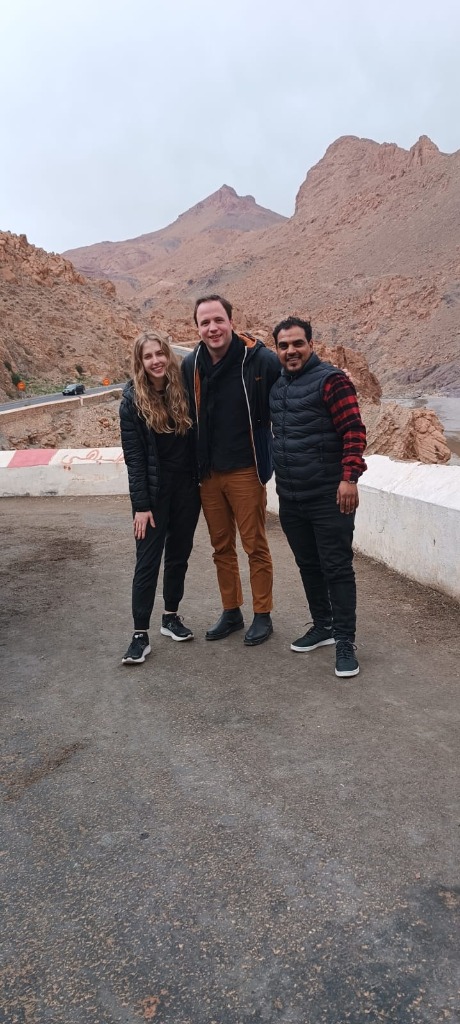 Travelers smiling with a guide in mountains